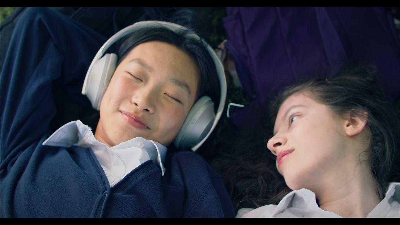 Evergreen stills of the two leads listening to music together