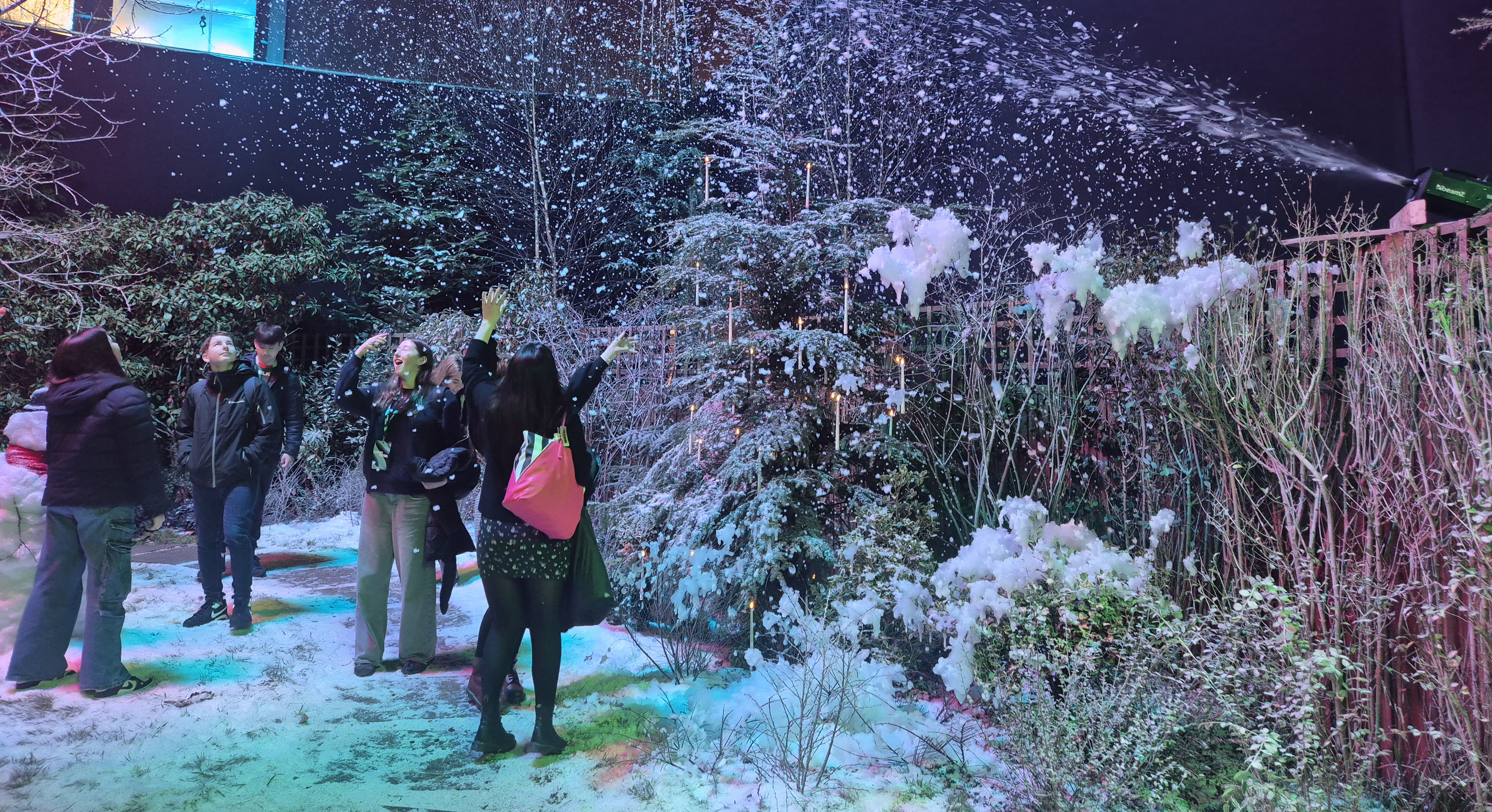 Students enjoying fake snow in winter studio set