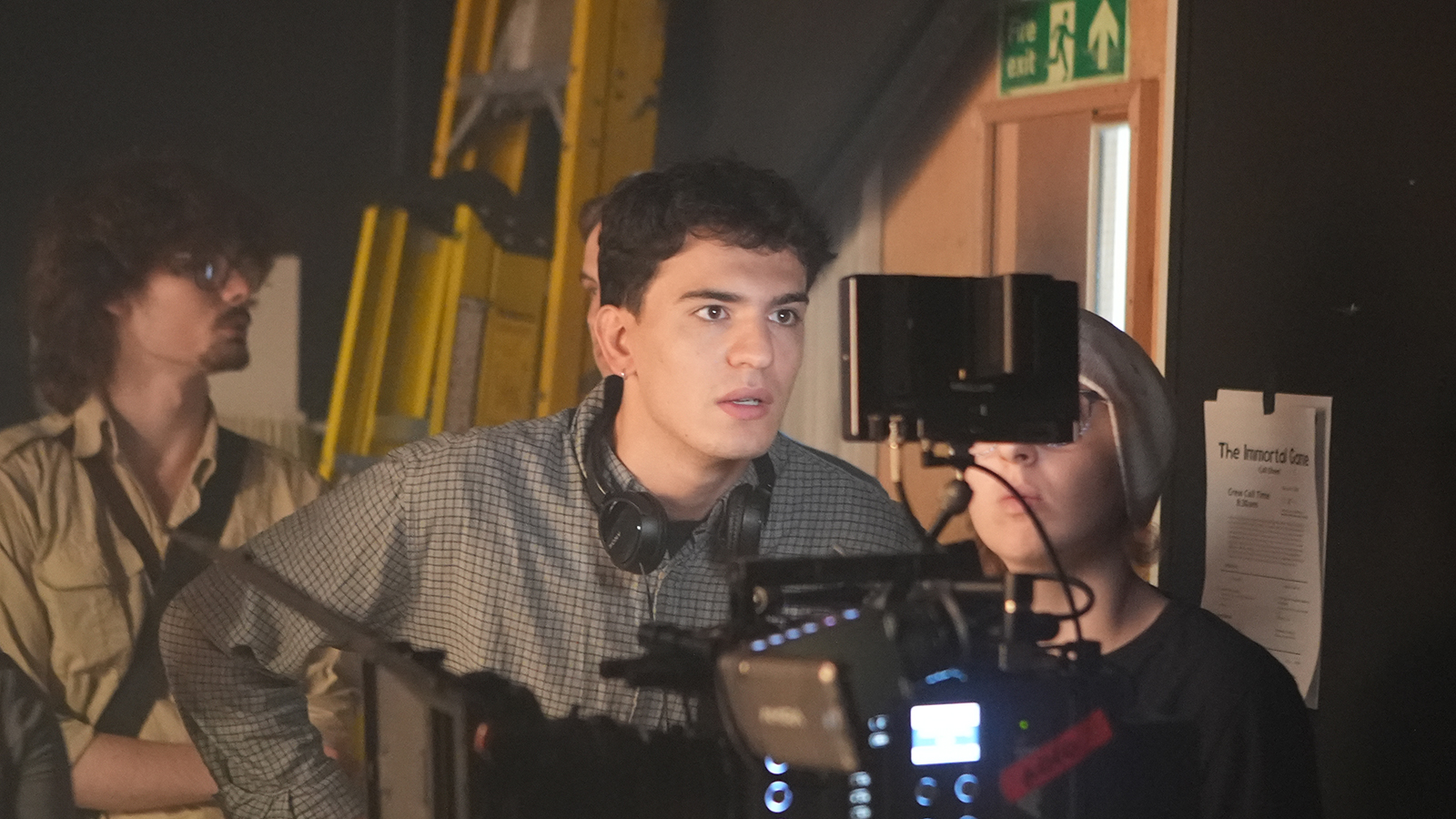 Student staring into camera monitor intently