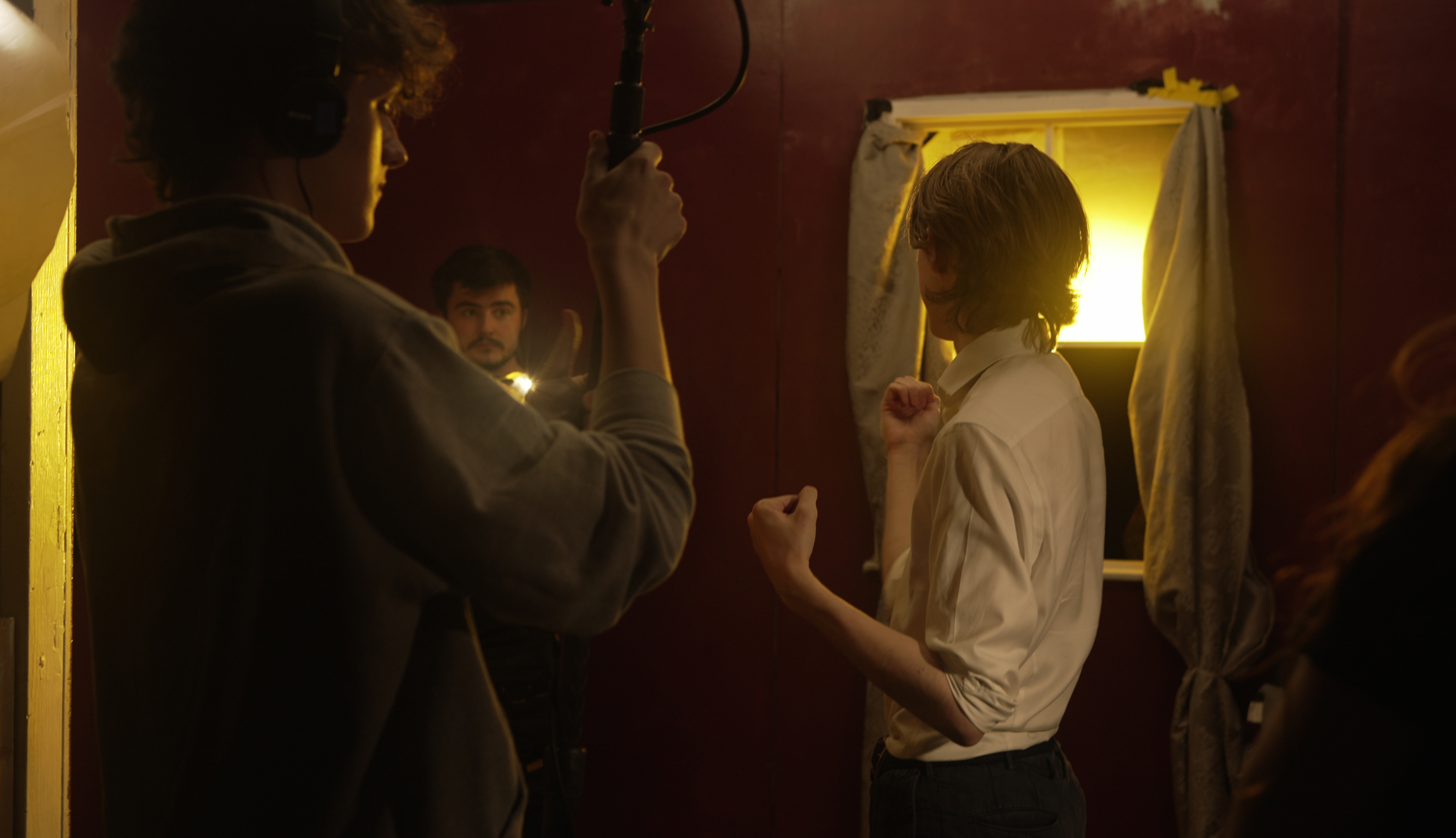 Students collaborating on film set