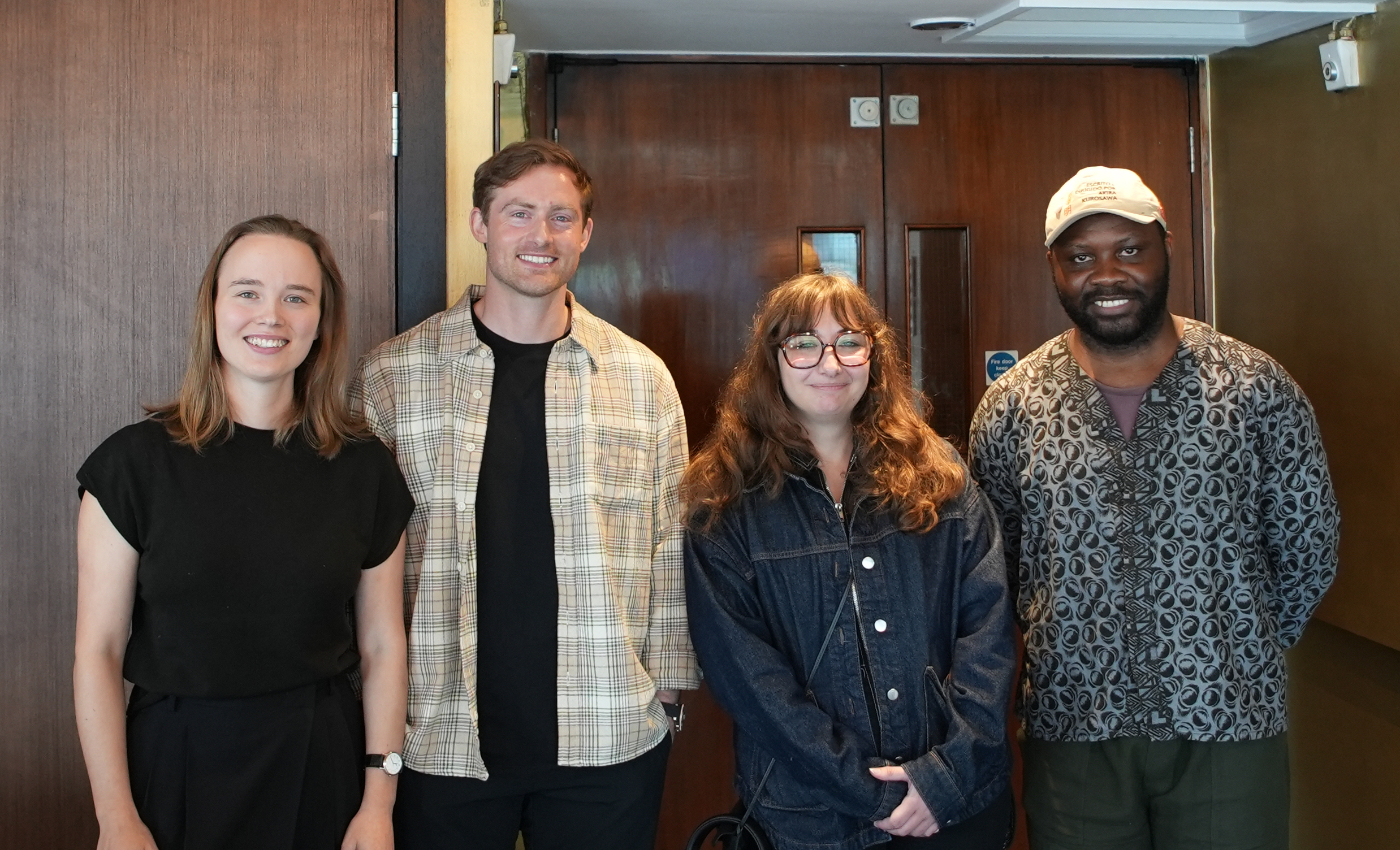 Four LFA graduates standing and smiling