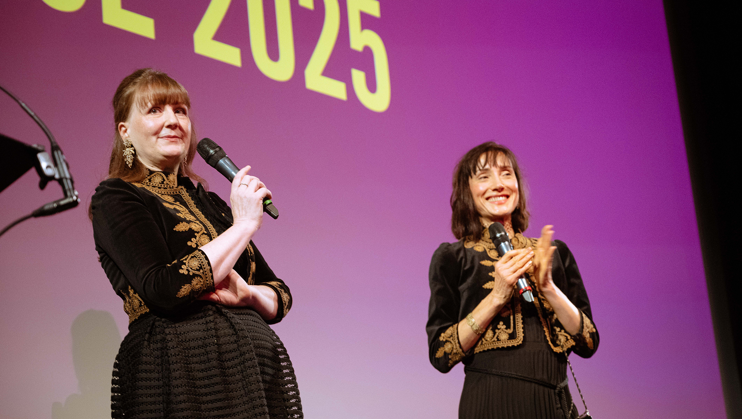 Joint principals Daisy and Anna smiling on stage