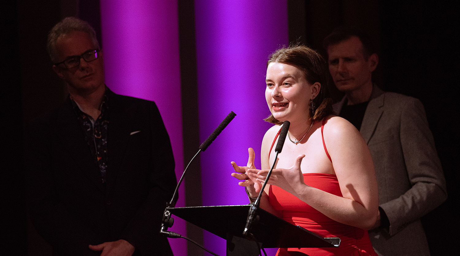 Female student giving speech onstage