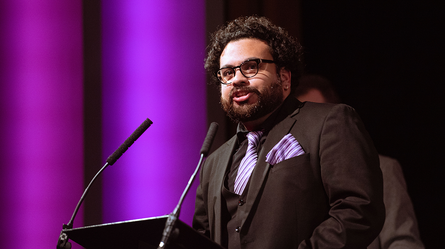 Male student giving speech onstage