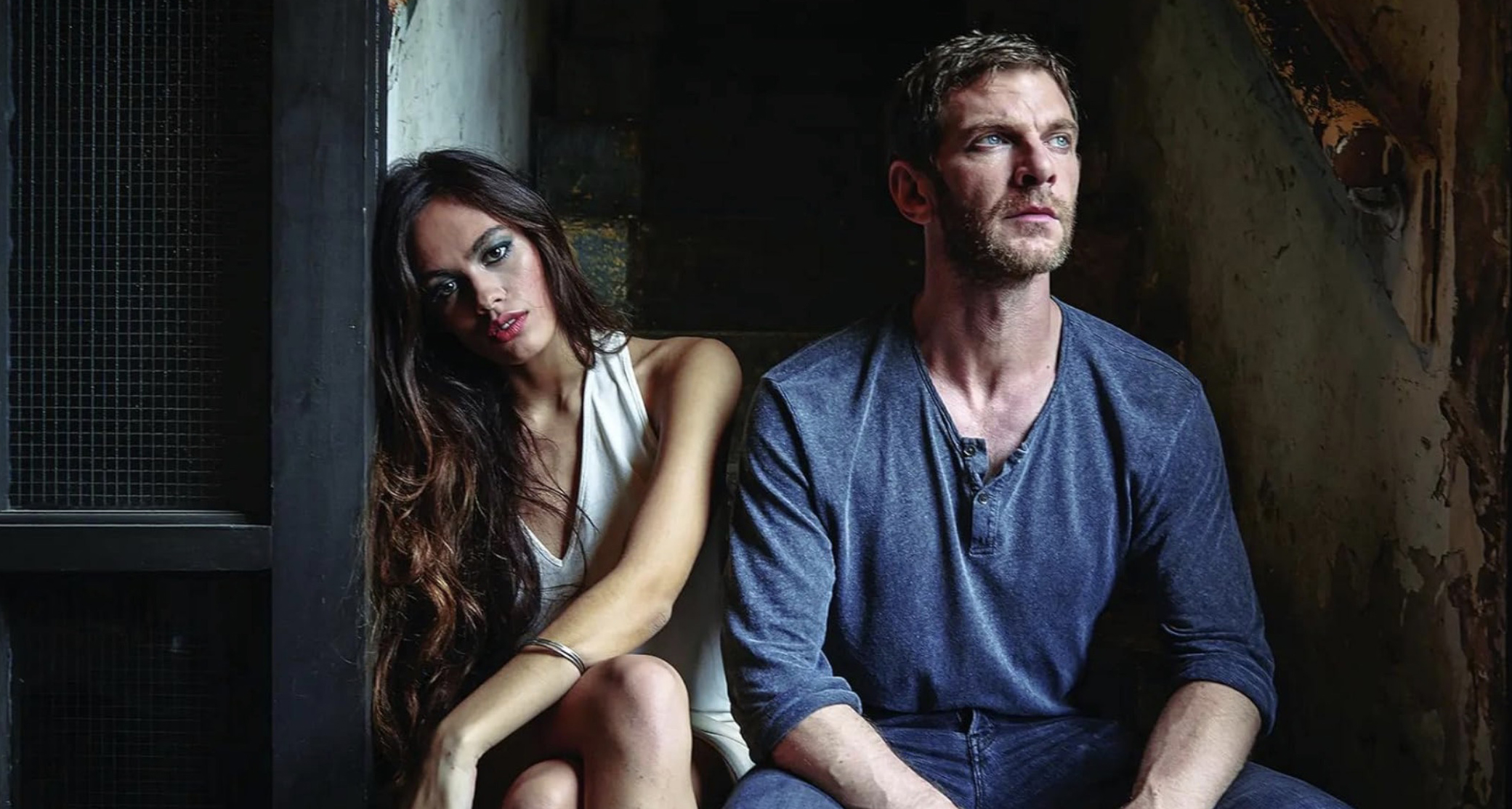 Man and woman sitting on step