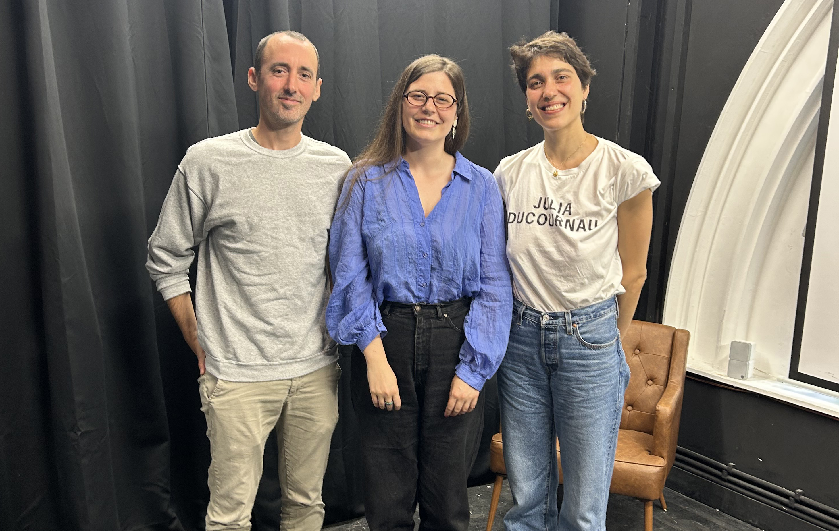 Three people standing together, smiling