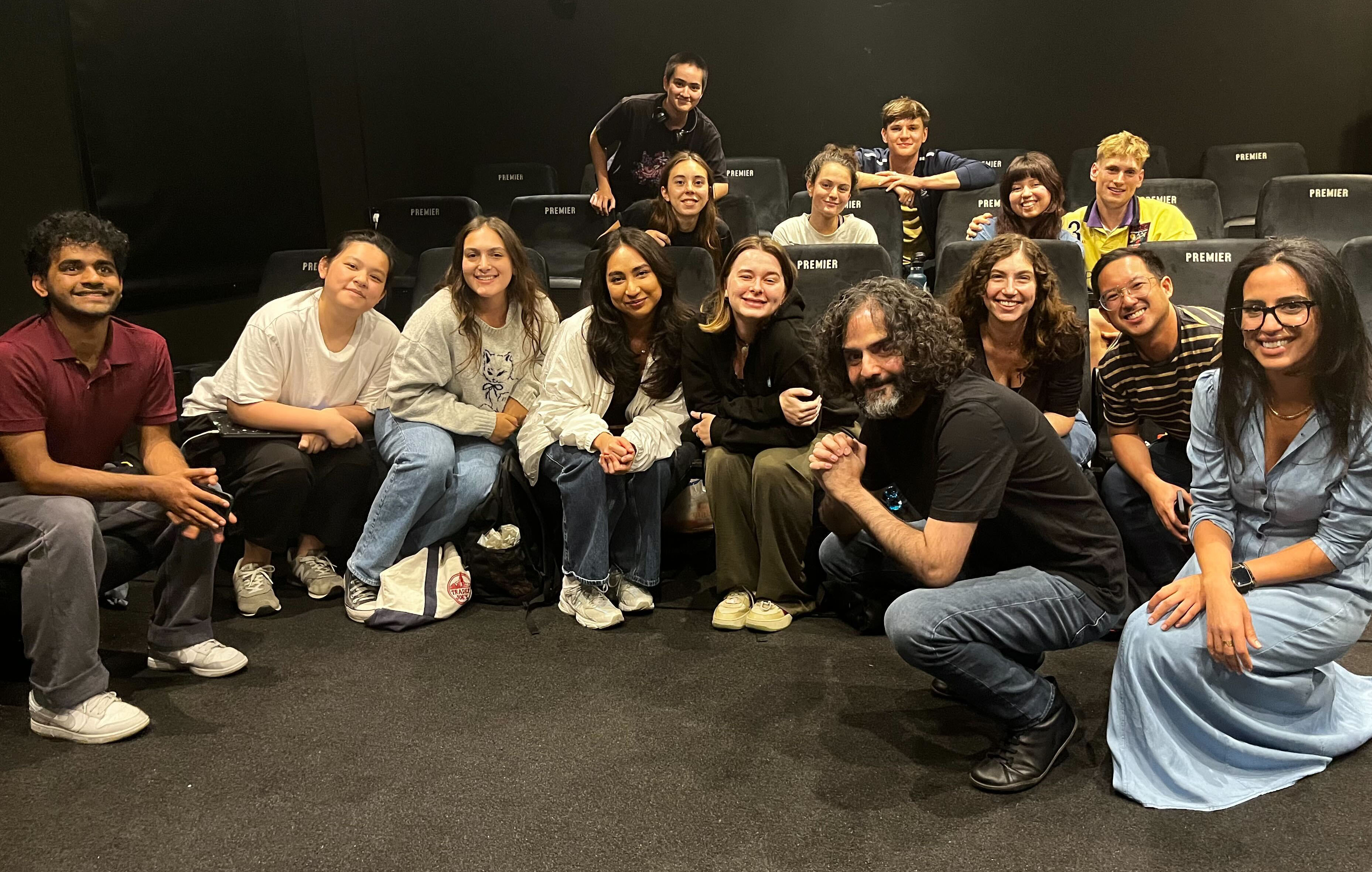 Filmmaker Babak Anvari posing for picture with LFA students, smiling