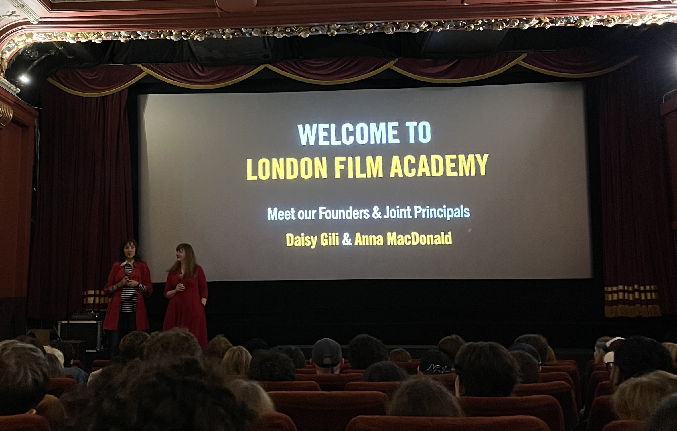 Joint Principals Anna MacDonald and Daisy Gili onstage in front of students