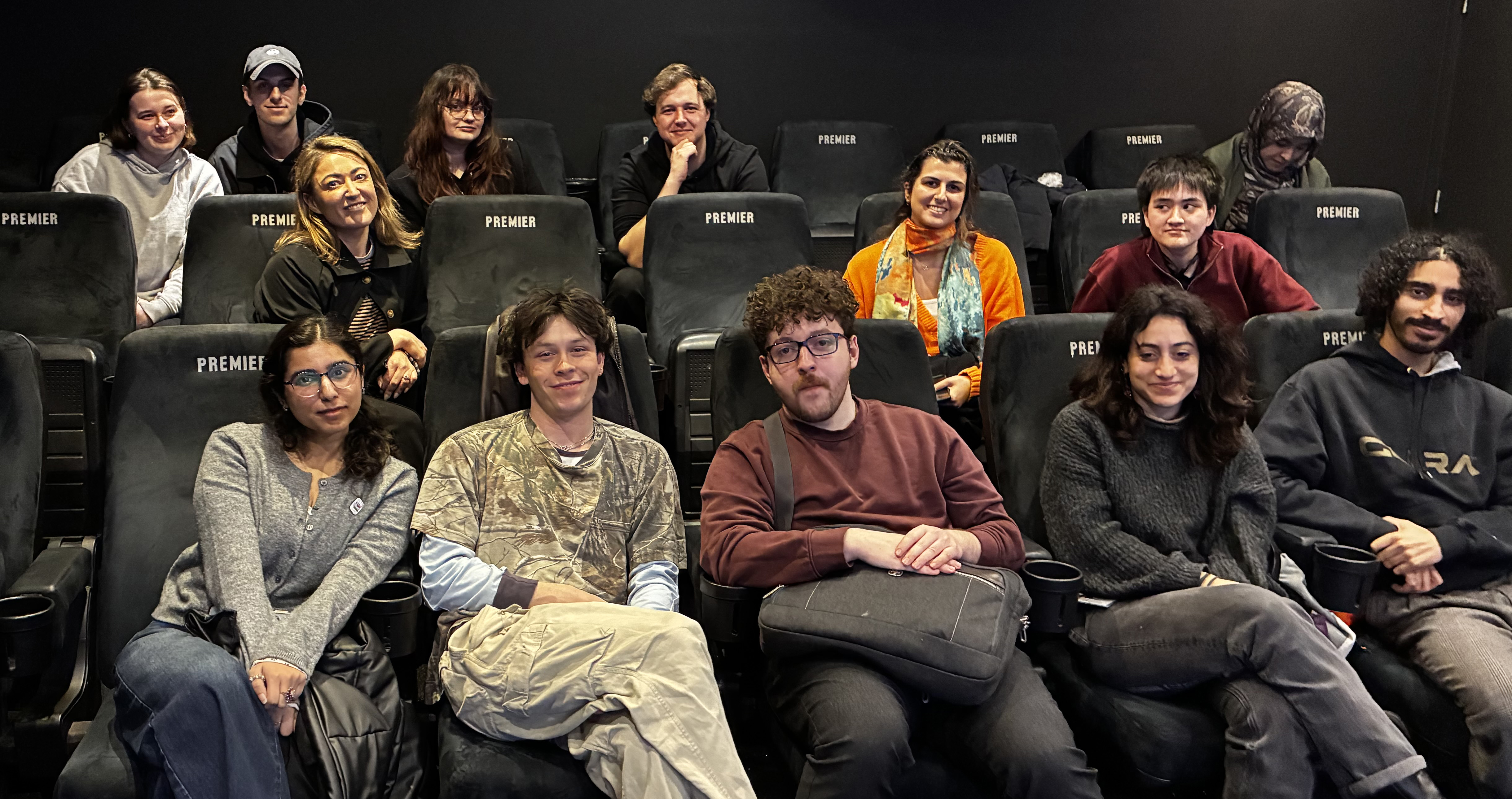 Cinema full of people sitting, smiling