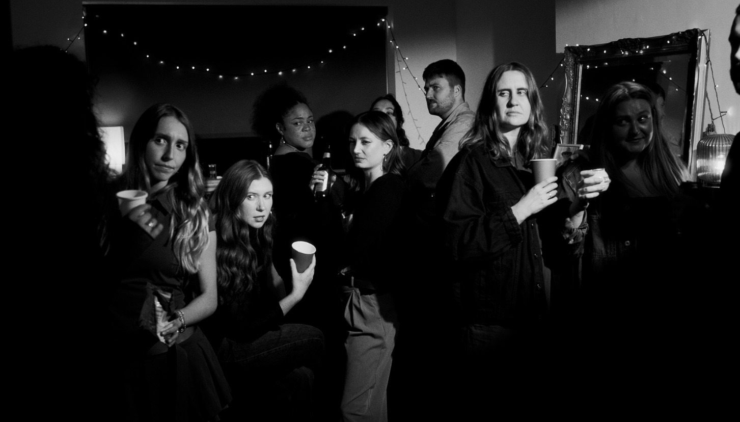 Students at a party, looking annoyed