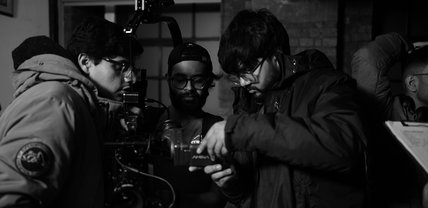 Students looking into camera monitor