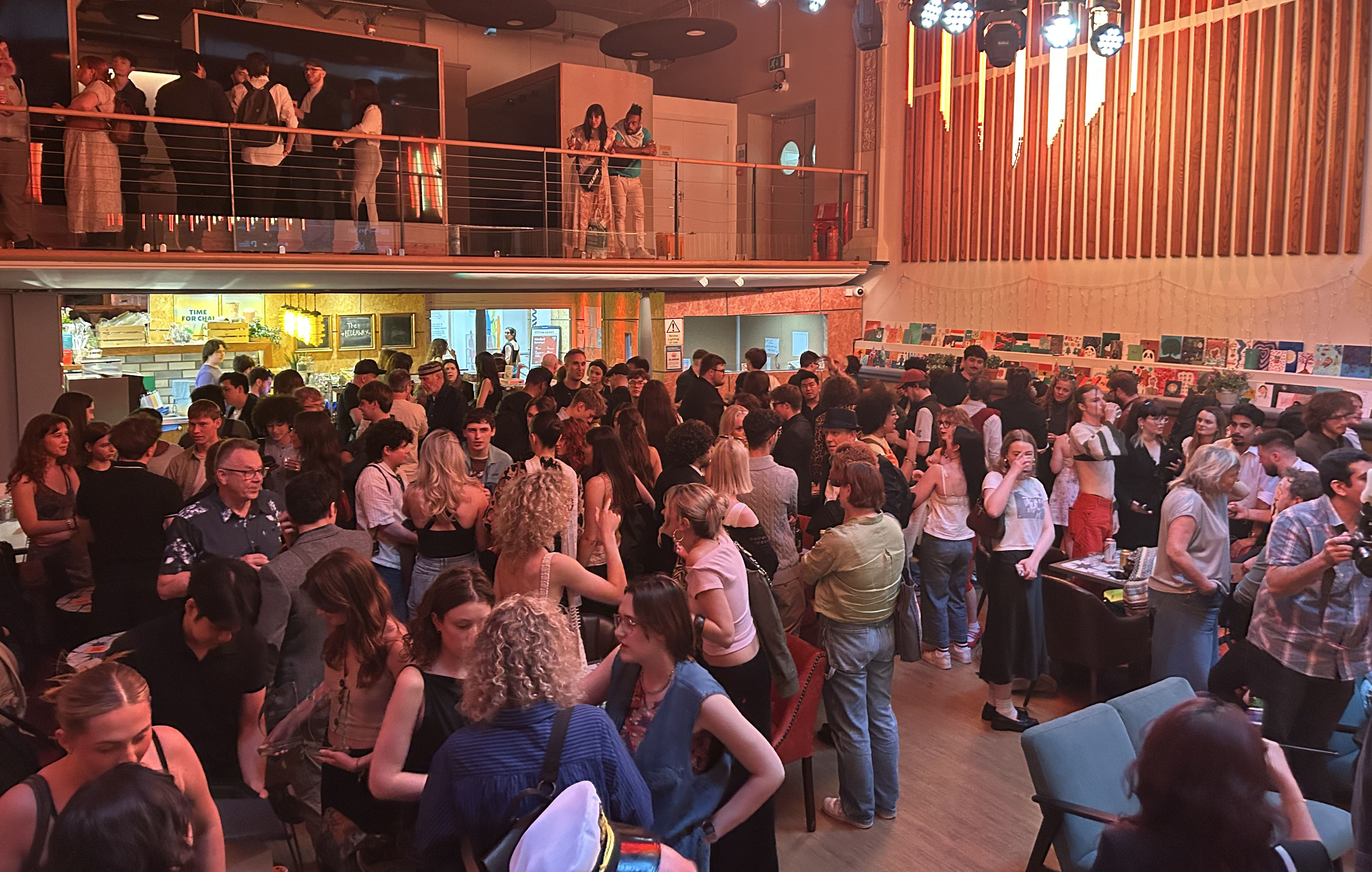 Large crowd of students enjoying drinks at awards afterparty