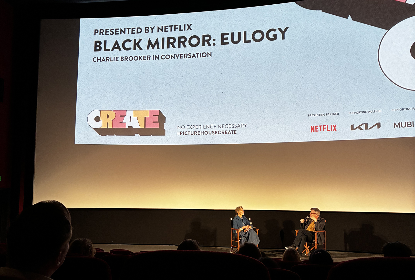 Man and woman on stage chatting