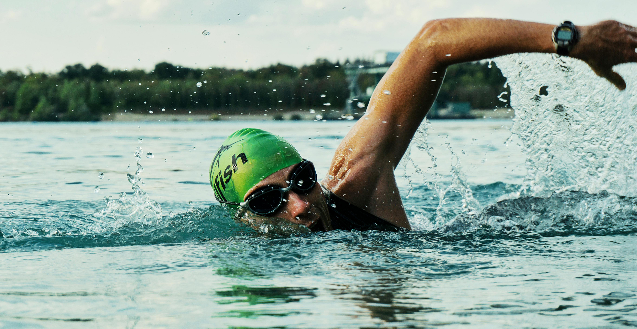Man swimming in cold winter lake
